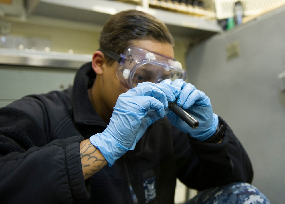 Future USS America armory sailors clean weapons