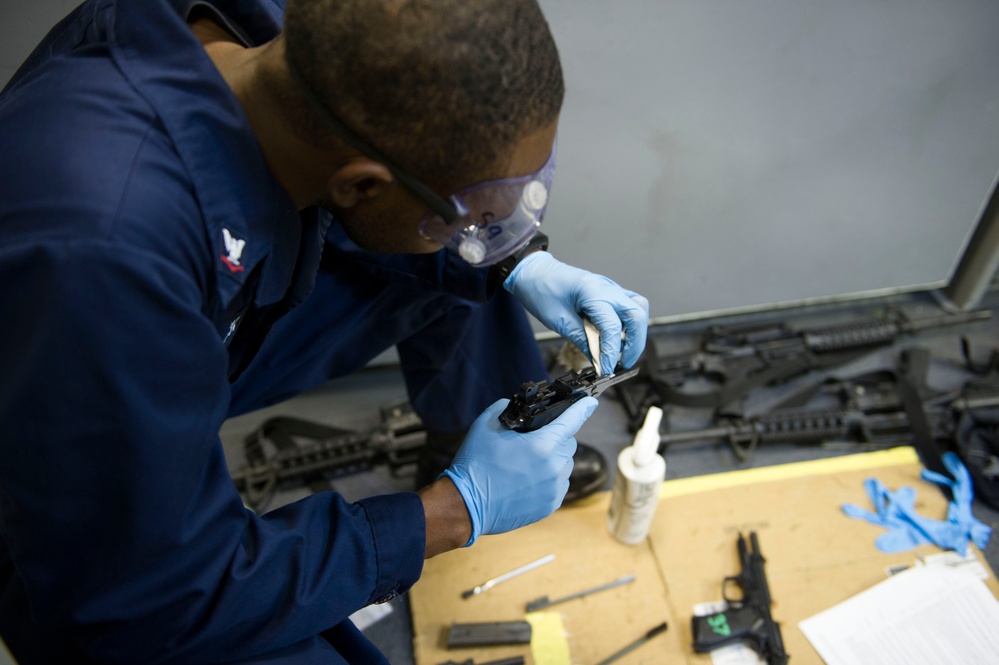 Future USS America armory sailors clean weapons