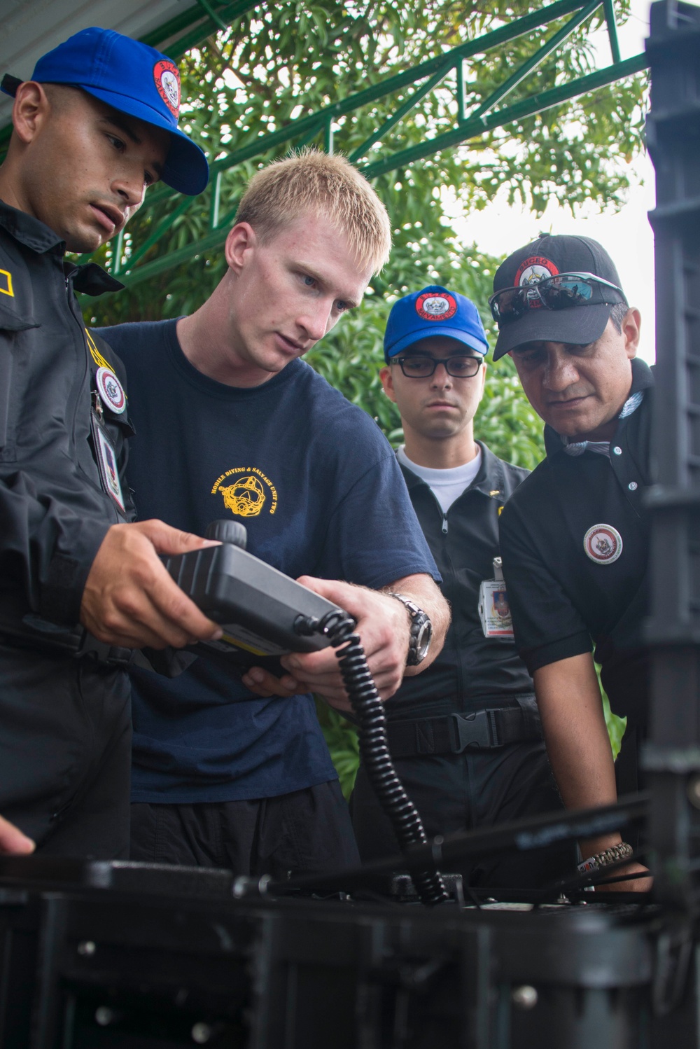 US Navy divers discuss their underwater robot with Colombian divers as part of Southern Partnership Station '14.