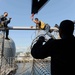 USS John C. Stennis Sailors install a safety net along the flight deck