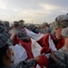 Airmen unfold a US flag at the 36th Annual Great Plains Stampede Rodeo