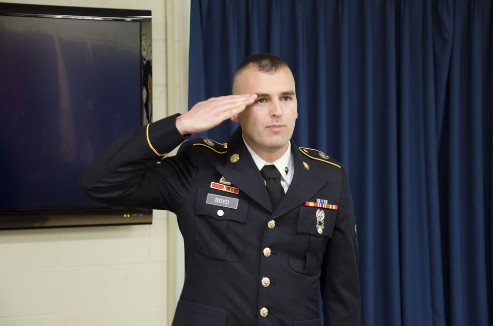 Spc. Boyd salutes at the CSM board