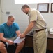 Staff member of Soldier Family Fit Facility shows results to Soldier
