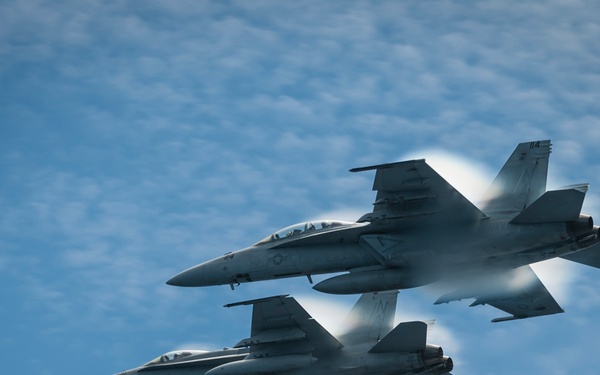 Aircraft fly over USS Carl Vinson