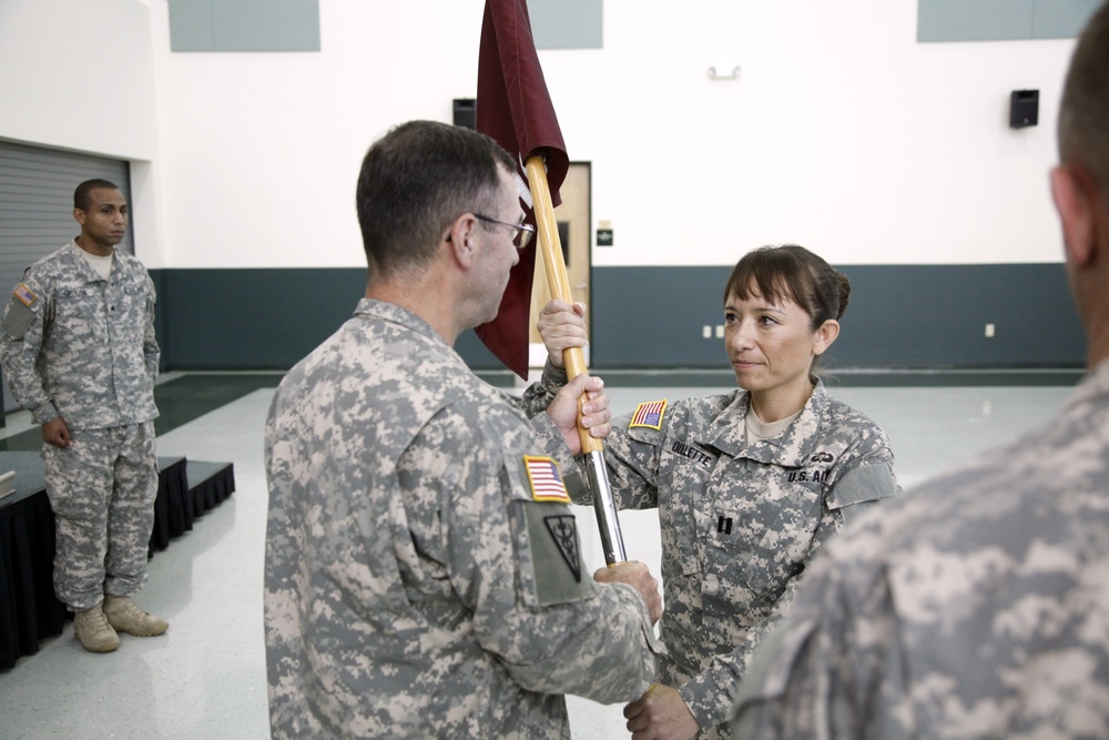 Maj. Gen. Bryan R.Kelly passes the company guidon to Capt. Ouellette, the incoming commander