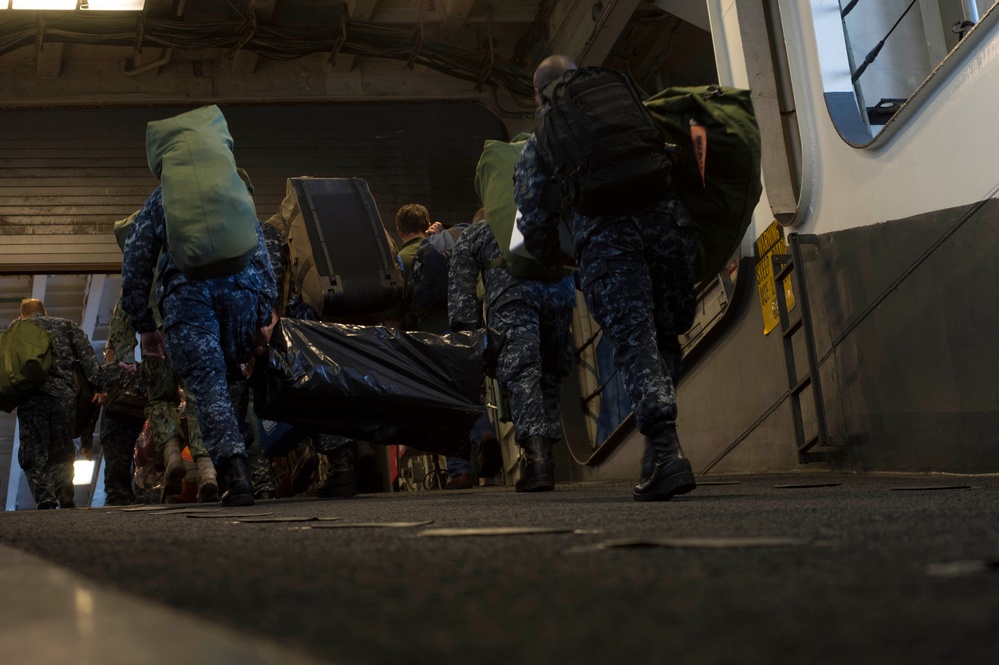 DVIDS Images Sailors, Marines carry gear aboard USS Iwo Jima [Image
