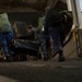 Sailors, Marines carry gear aboard USS Iwo Jima