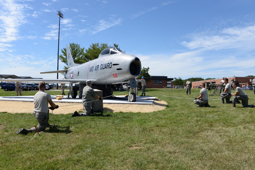 Members of the 175th Maintenance Group, Crash Damaged Disabled Aircraft Recovery (CDDAR) team riase aircraft