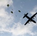 Paratroopers jump out of a Canadian C-130J Hercules