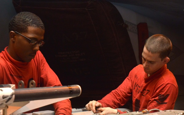 USS George Washington sailors clean ejector rack