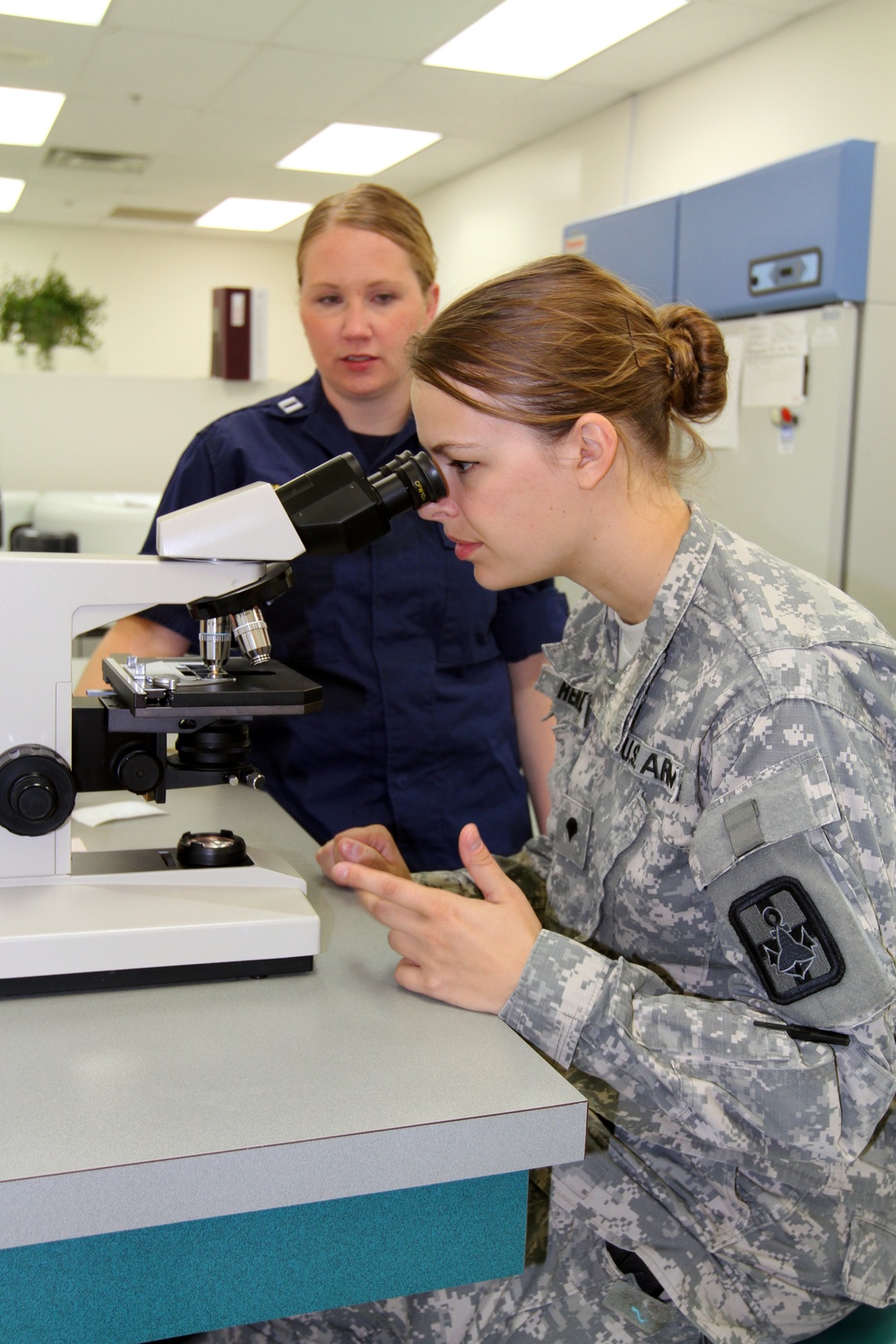 Army Reserve combat medic reviews urine sample in lab