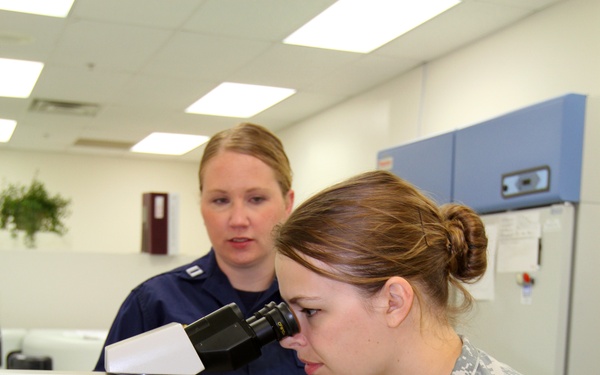Army Reserve combat medic reviews urine sample in lab