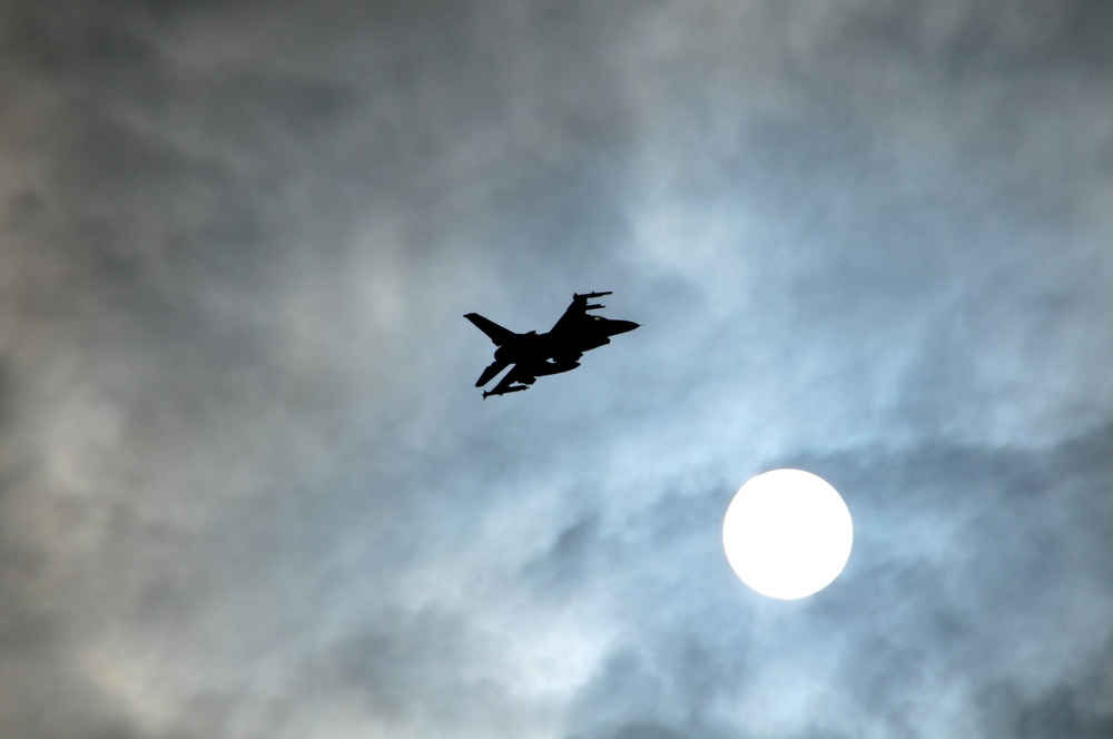 F-16 climbs above afternoon sun