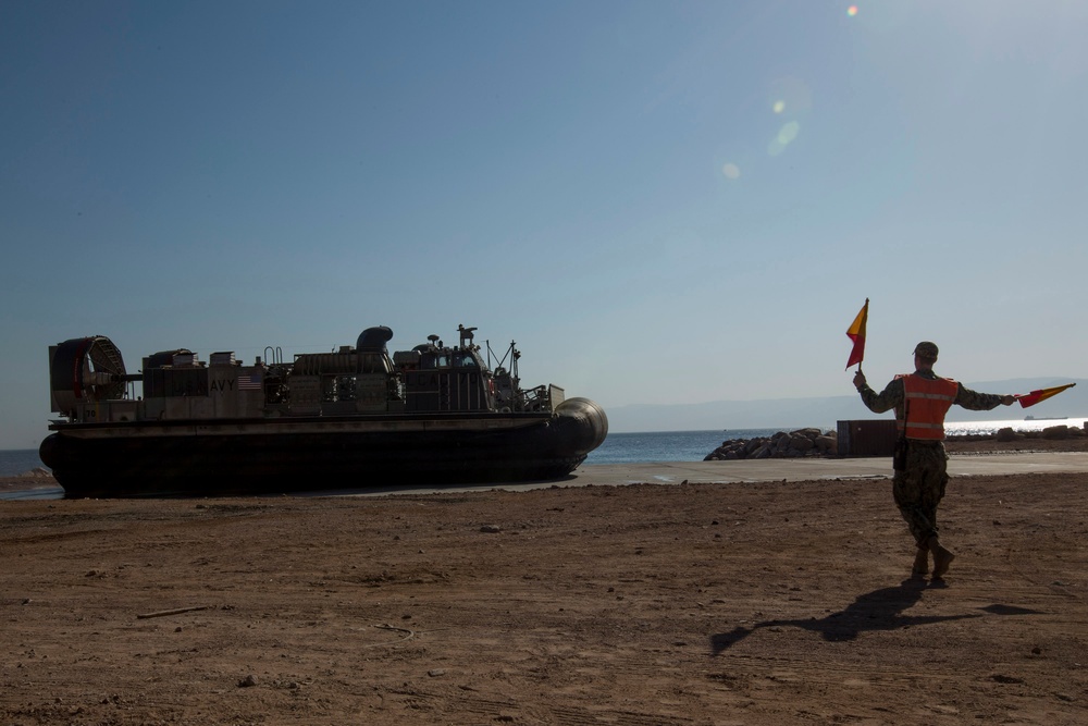 Mesa Verde transport vehicles aboard LCACs to start wash down