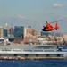 Coast Guard Air Station Atlantic City MH-65 Dolphin crew flies over Baltimore’s Inner Harbor as Star-Spangled Spectacular draws to a close
