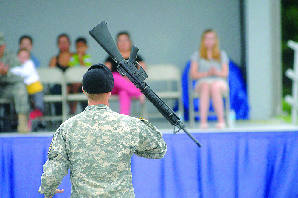 Soldier twirls weapon during competition