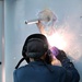 Sparks fly as 11th MEU Marines work on USS Comstock