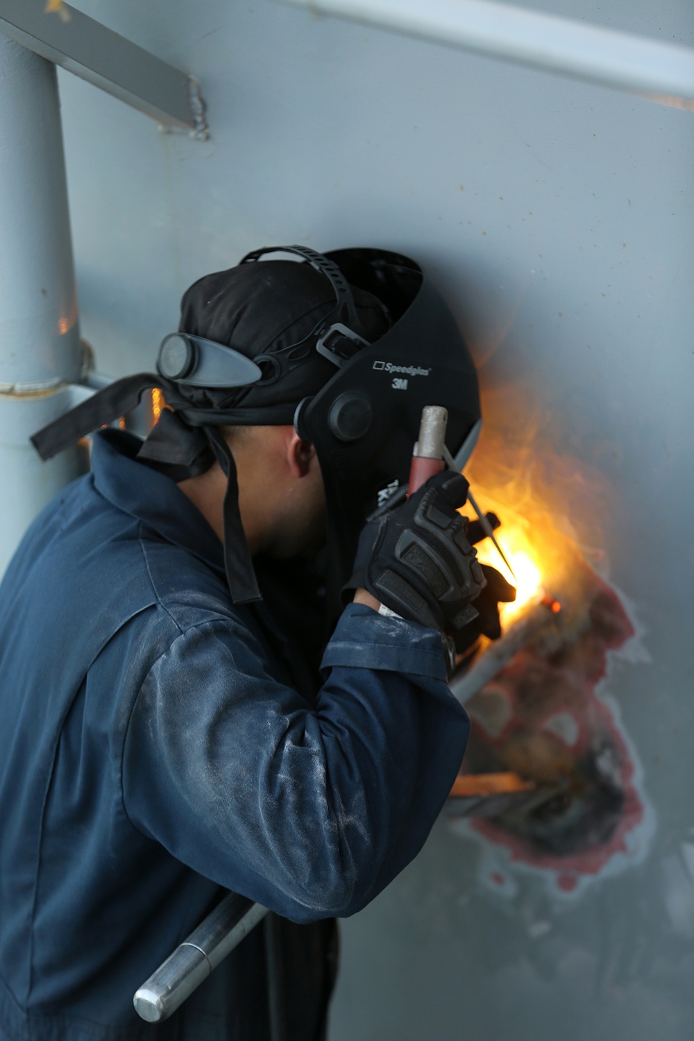 Sparks fly as 11th MEU Marines work on USS Comstock