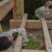 Soldier helps teammate overcome obstacle