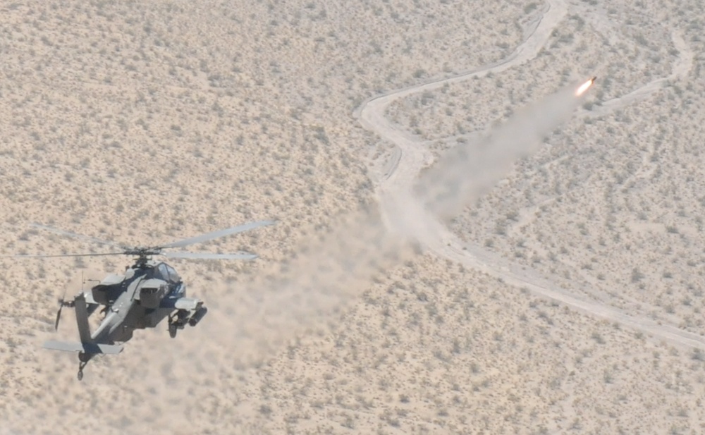 Apache attack helicopter fires a Hellfire missile
