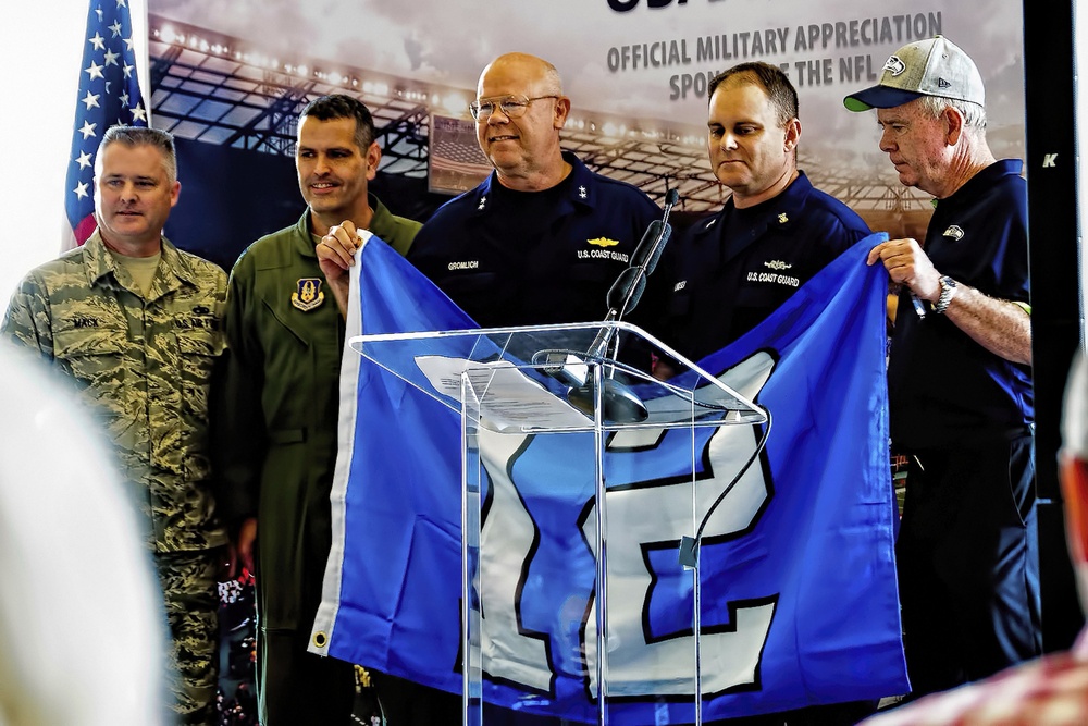 446th AW passes Seahawks' 12th-Man flag to Coast Guard