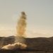 Soldiers fire an M58 Mine Clearing Line Charge rocket to breach an enemy gate