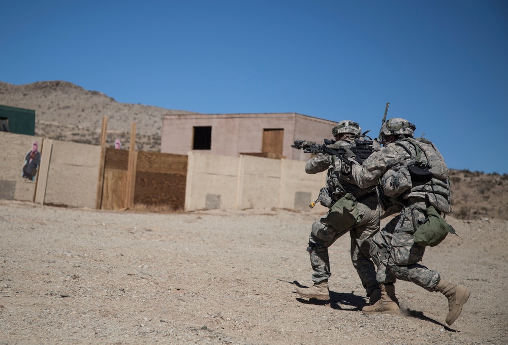 Soldiers breach and attack enemy compound