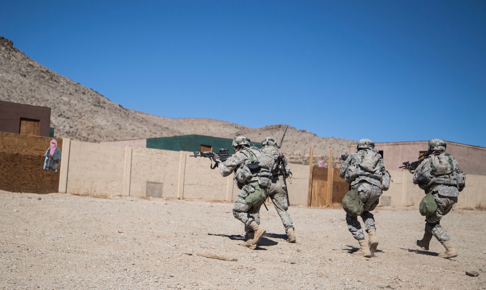 Soldiers breach and attack enemy compound