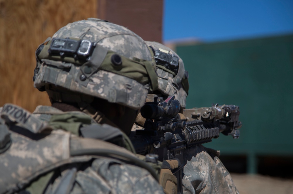 Soldiers breach and attack enemy compound