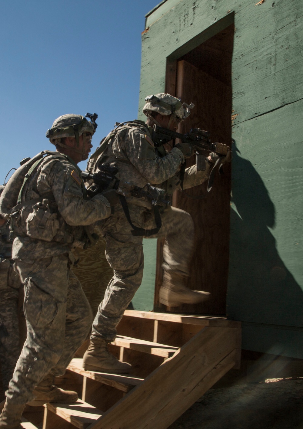 Soldiers breach and attack enemy compound