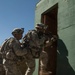 Soldiers breach and attack enemy compound