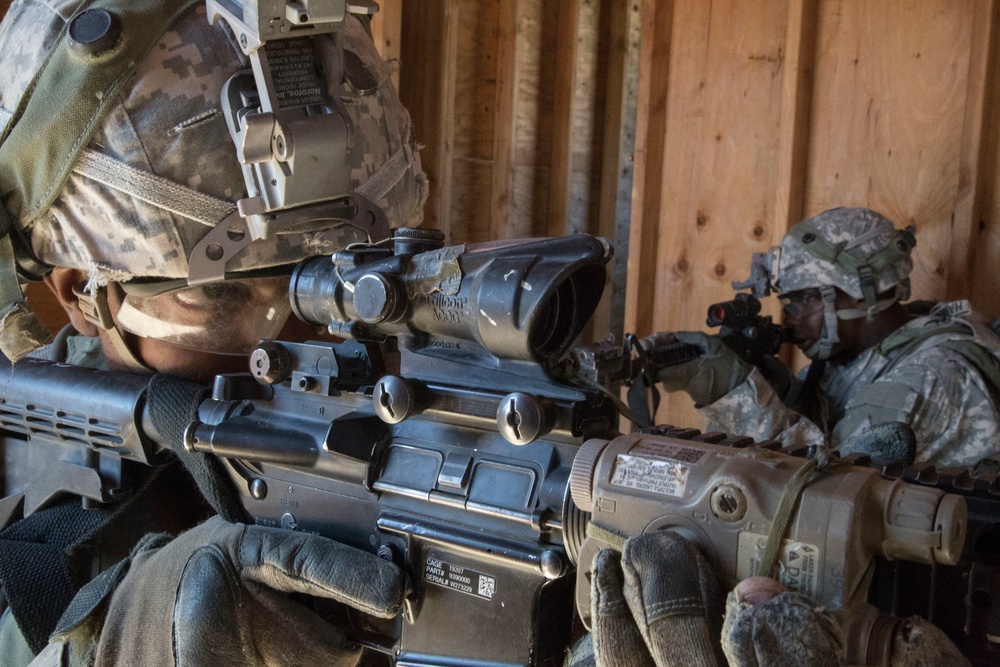 Soldiers breach and attack enemy compound