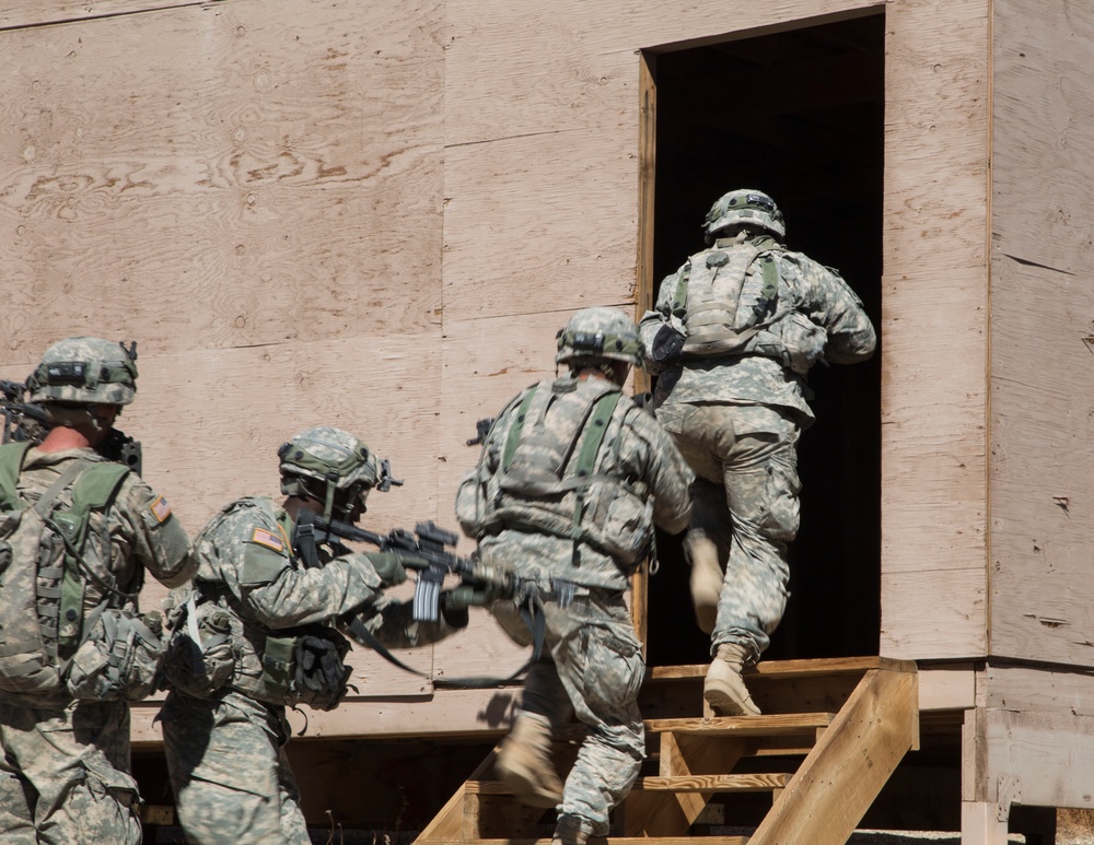 Soldiers breach and attack enemy compound