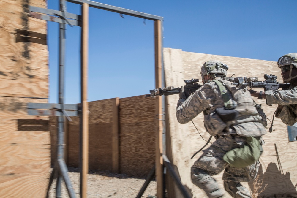 Soldiers breach and attack enemy compound