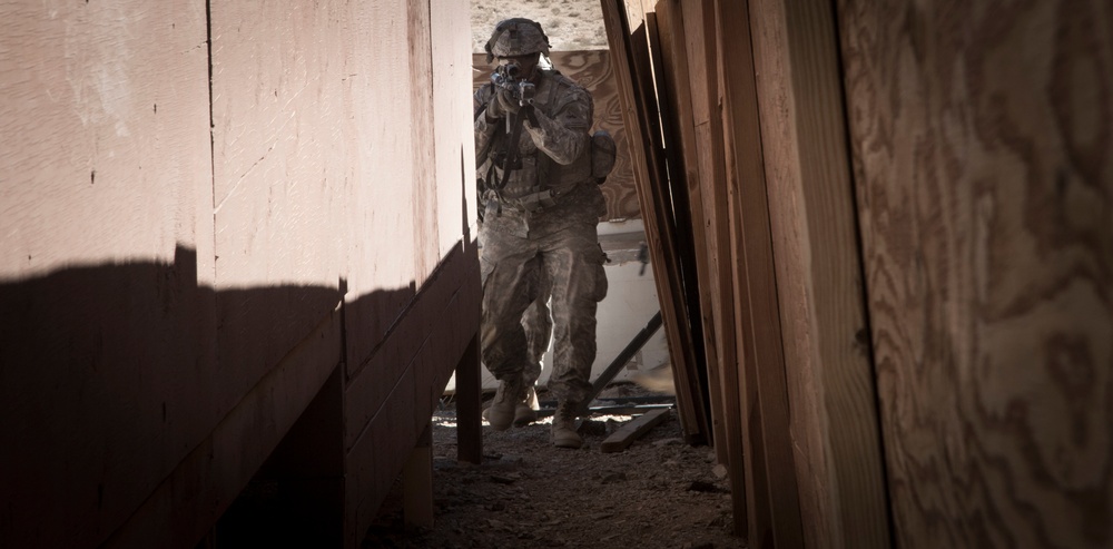 Soldiers breach and attack enemy compound