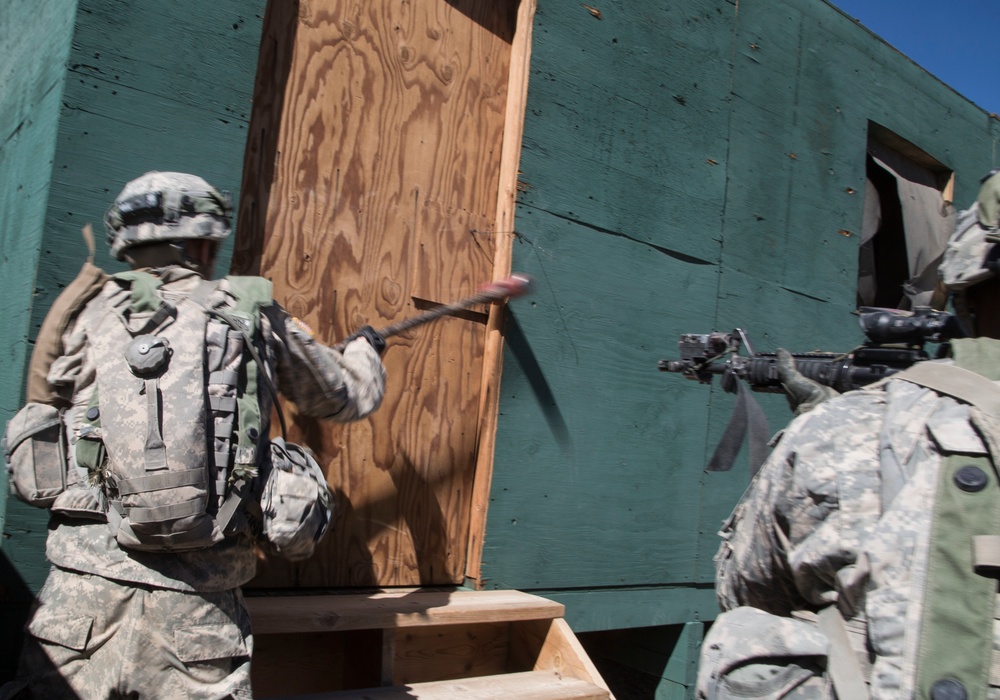 Soldiers breach and attack enemy compound