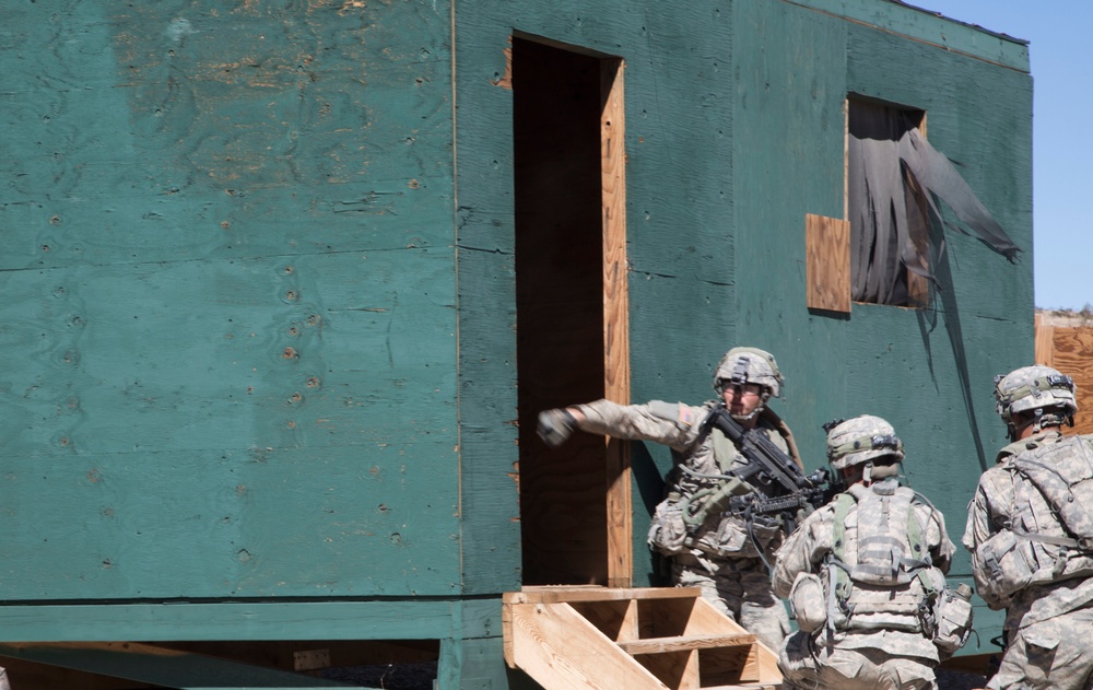 Soldiers breach and attack enemy compound