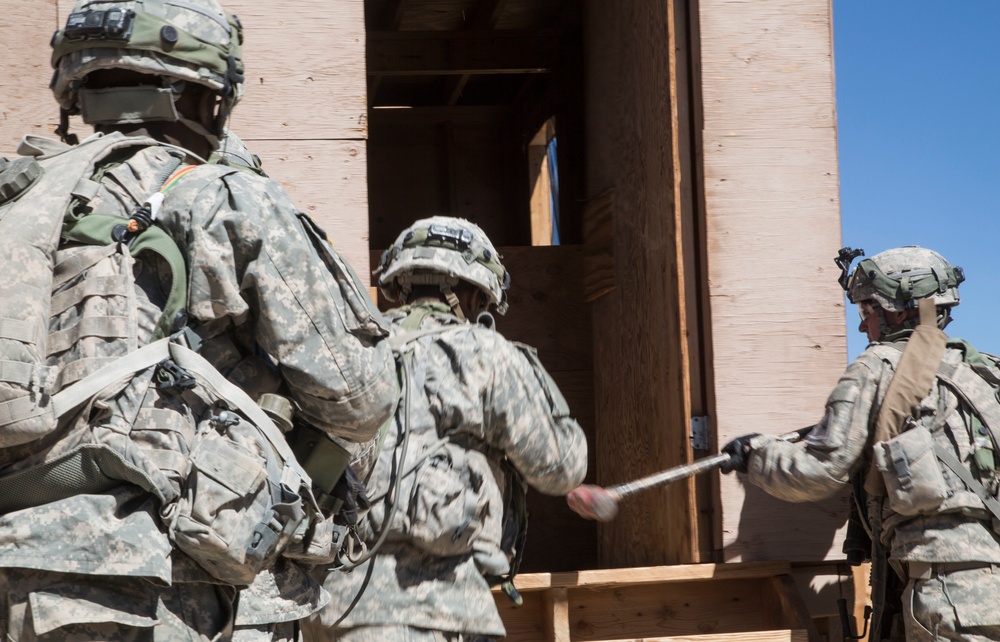 Soldiers breach and attack enemy compound