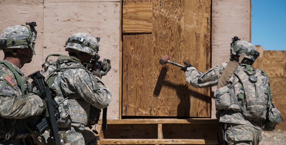 Soldiers breach and attack enemy compound