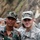 Two soldiers from different military forces pose together for a photo in what appears to be an outdoor field environment with rocky terrain in the background. The soldier on the left wears Indian Army DPM (Disruptive Pattern Material) camouflage uniform with tactical vest and magazine pouches, while the soldier on the right wears U.S. Army ACU (Army Combat Uniform) with the name tape 'MAIER' and 'U.S. ARMY' tape visible. The setting and mixed uniforms suggest a joint military exercise or bilateral training event.