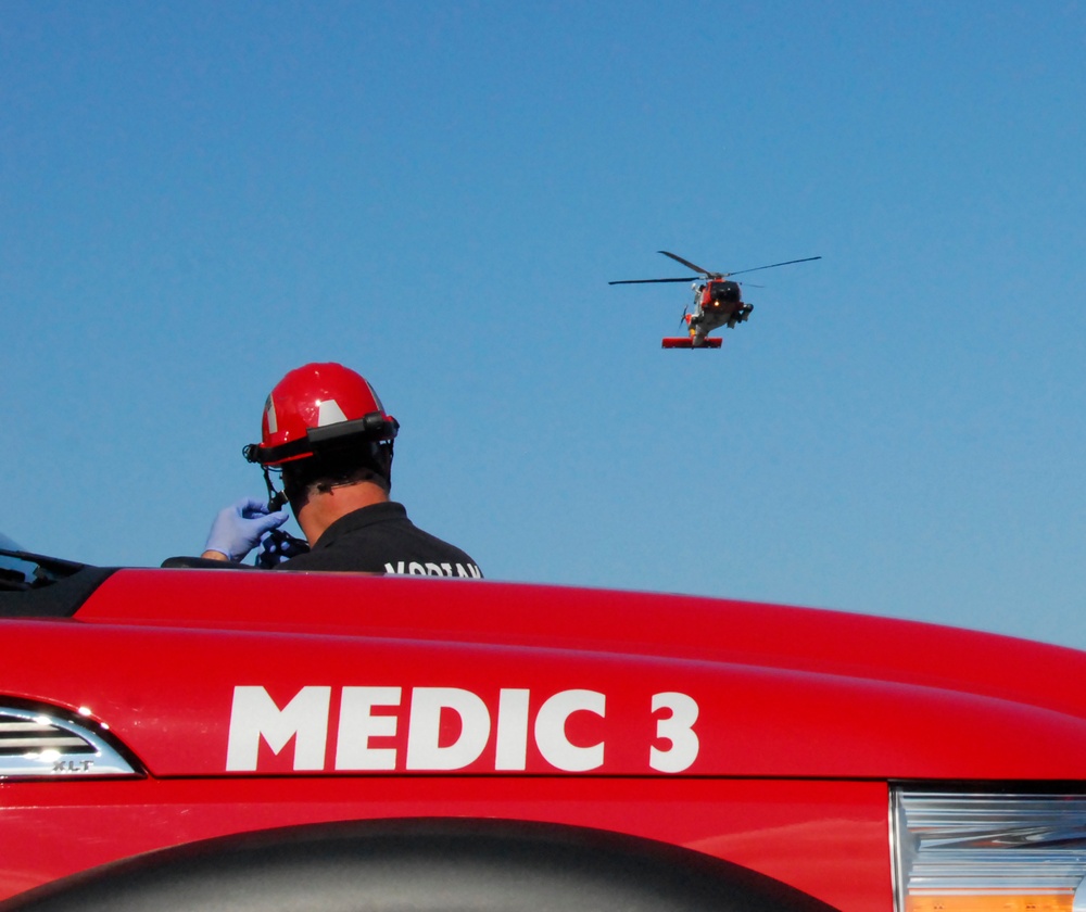 Coast Guard MH-60 Jayhawk helicopter crew delivers an injured ATV rider to awaiting fire rescue