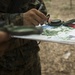 Parris Island recruits guide themselves through wooded areas using a map, compass