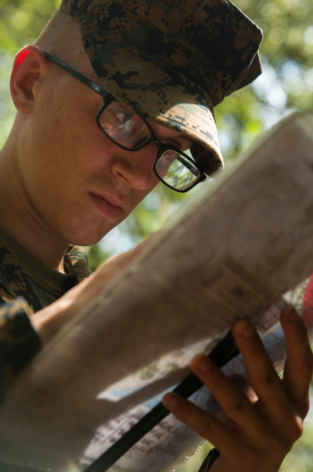 Parris Island recruits guide themselves through wooded areas using a map, compass