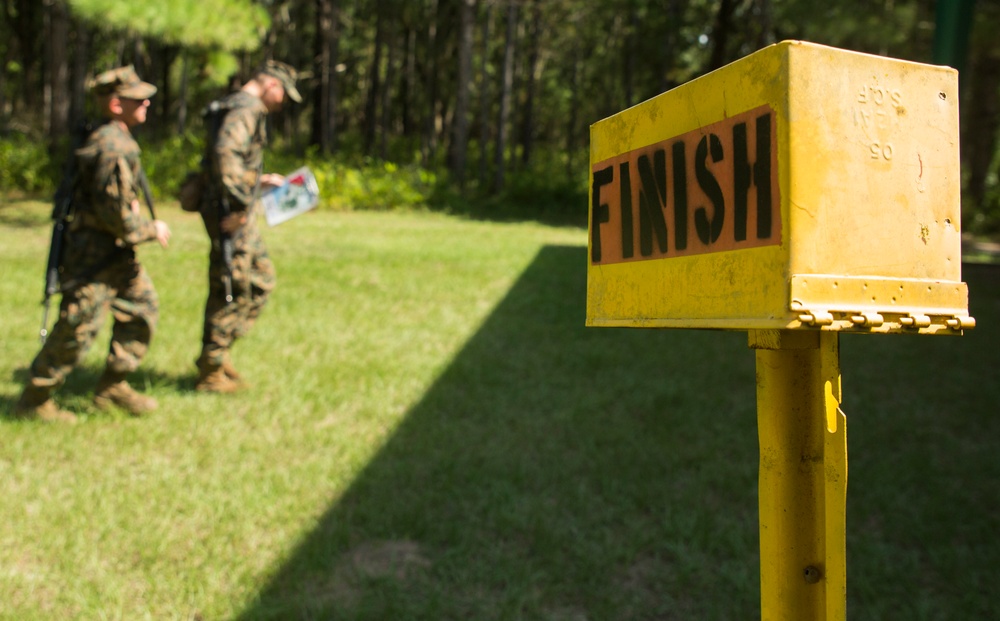 Parris Island recruits guide themselves through wooded areas using a map, compass