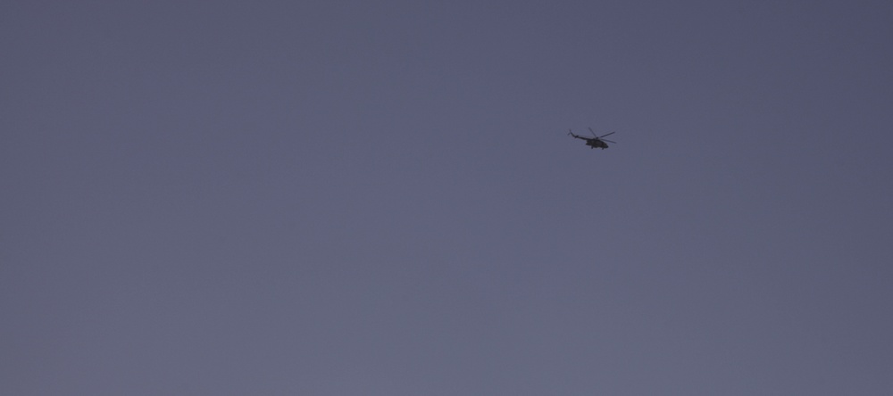 Afghan air force helicopter flies over Forward Operating Base Gamberi