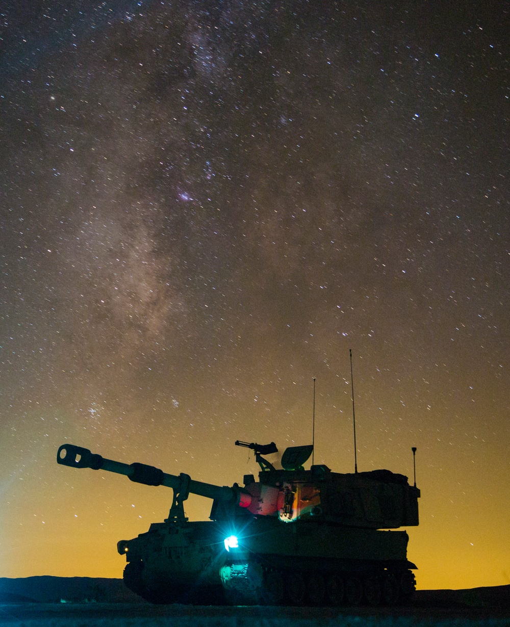 Soldiers patrol with an M109A6 throughout the night