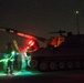 Soldiers patrol with an M109A6 throughout the night