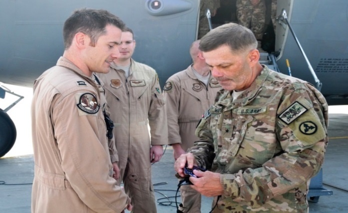 Brig. Gen. Donnie Walker Jr., commanding general of the 3d Sustainment Command (Expeditionary) recognizes Capt. Nick Burke, flight commander with 17th Airlift Squadron