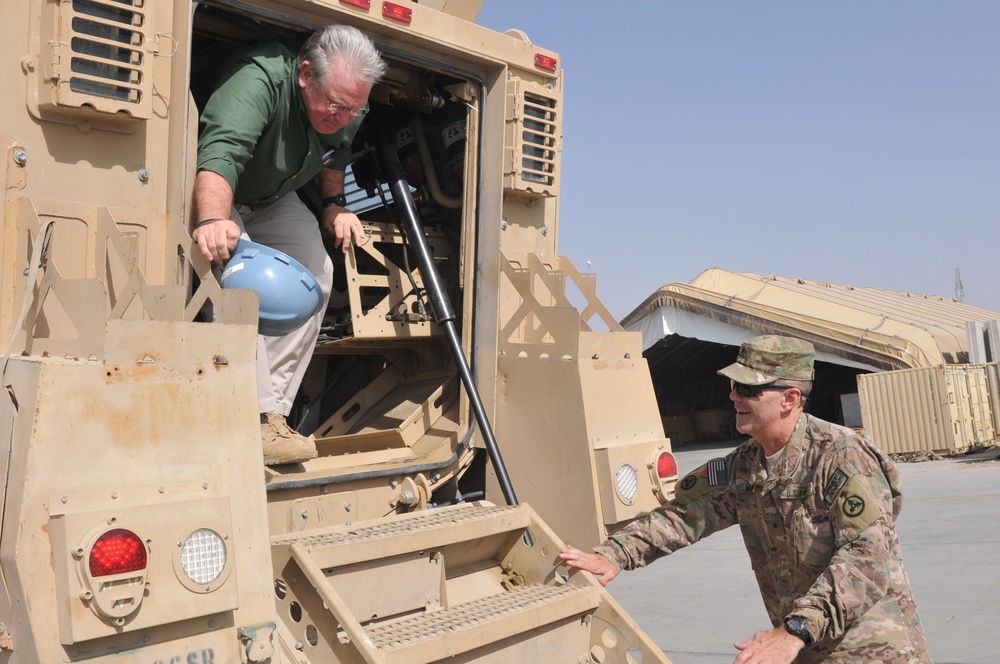 Missouri Gov. Jay Nixon is greeted by Brig. Gen. Donnie Walker Jr., commanding general of the 3d Sustainment Command (Expeditionary), as he exits MRAP