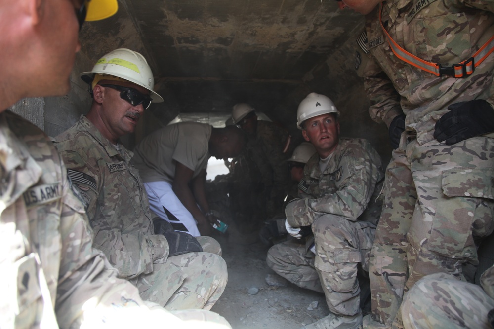 US Army Soldiers take cover after an indirect fire attack at Bagram Air Field